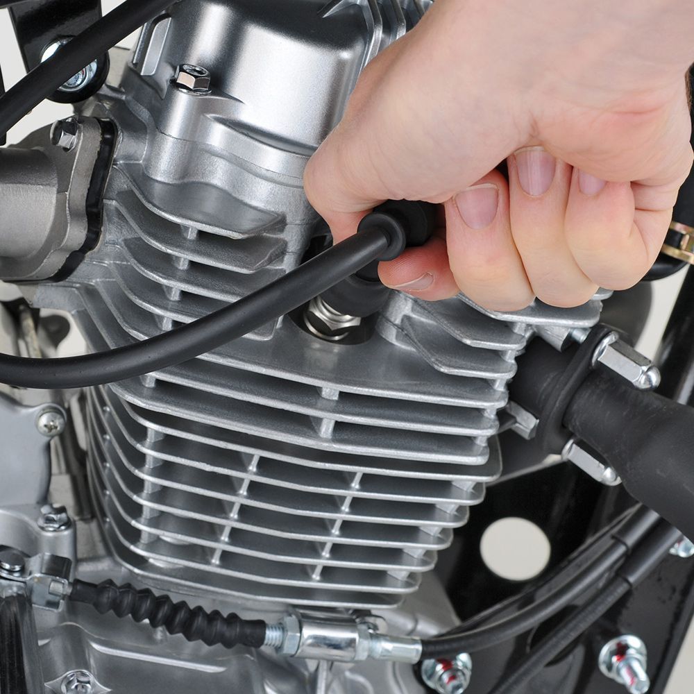 a person is working on a motorcycle engine