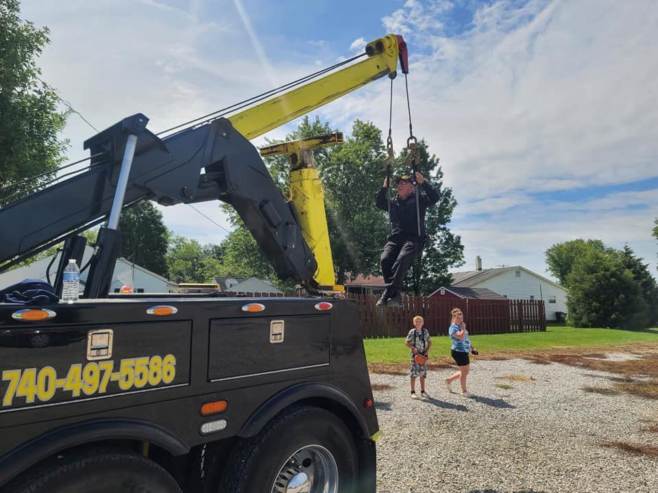 A tow truck with a yellow crane attached to it