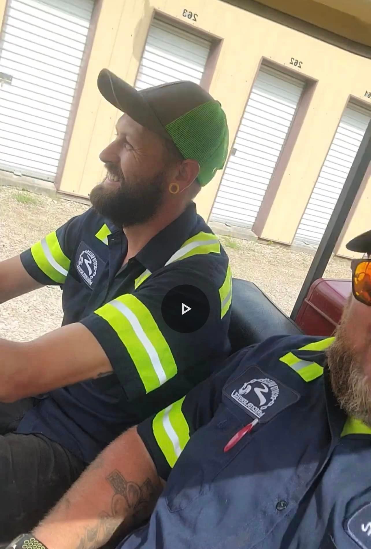 Two men are sitting in a golf cart.