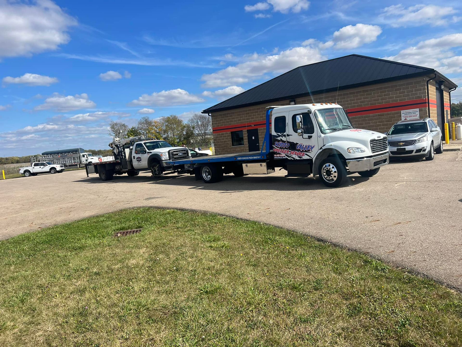 A tow truck is parked in front of a building.
