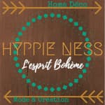 A logo for hippie ness l' esprit boheme on a wooden background.
