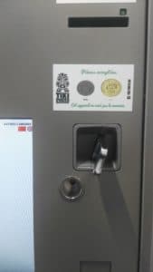 A close up of a vending machine with a sticker on it.