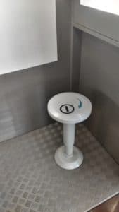 A small white table is sitting in the corner of a room.