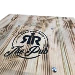 A close up of a wooden table with a logo on it.