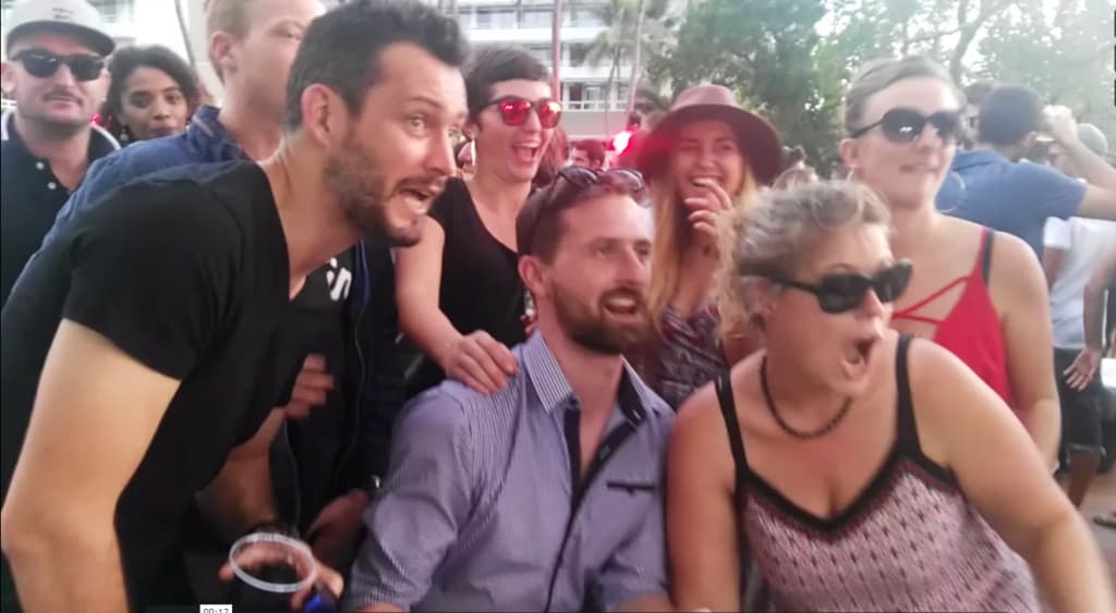 A group of people are posing for a picture in a crowd.