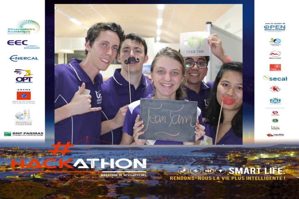 A group of people are posing for a photo in front of a sign that says hackathon