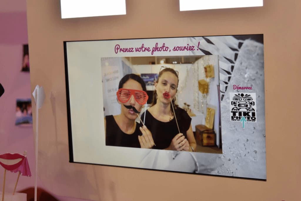 A picture of two women wearing fake mustaches and glasses