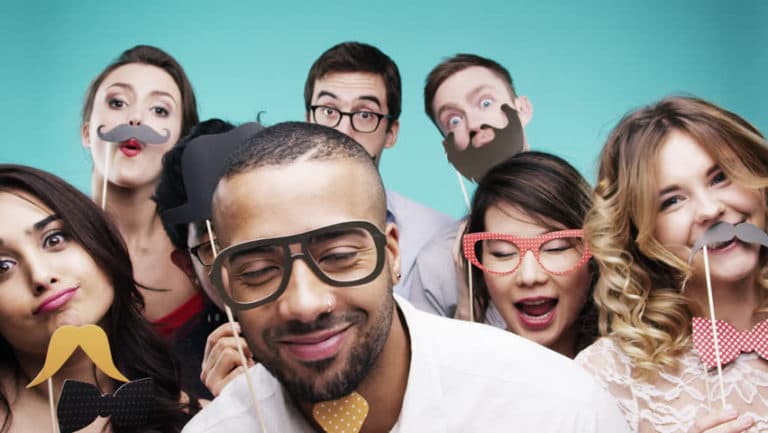A group of people are posing for a picture in a photo booth.