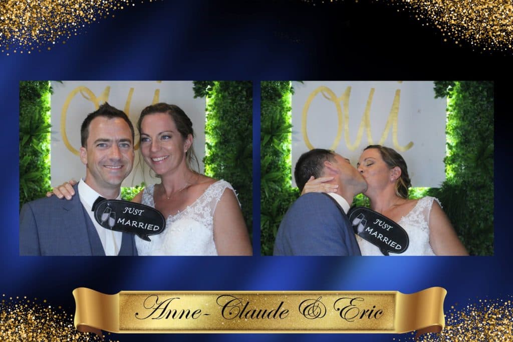 A bride and groom are posing for a picture in a photo booth.