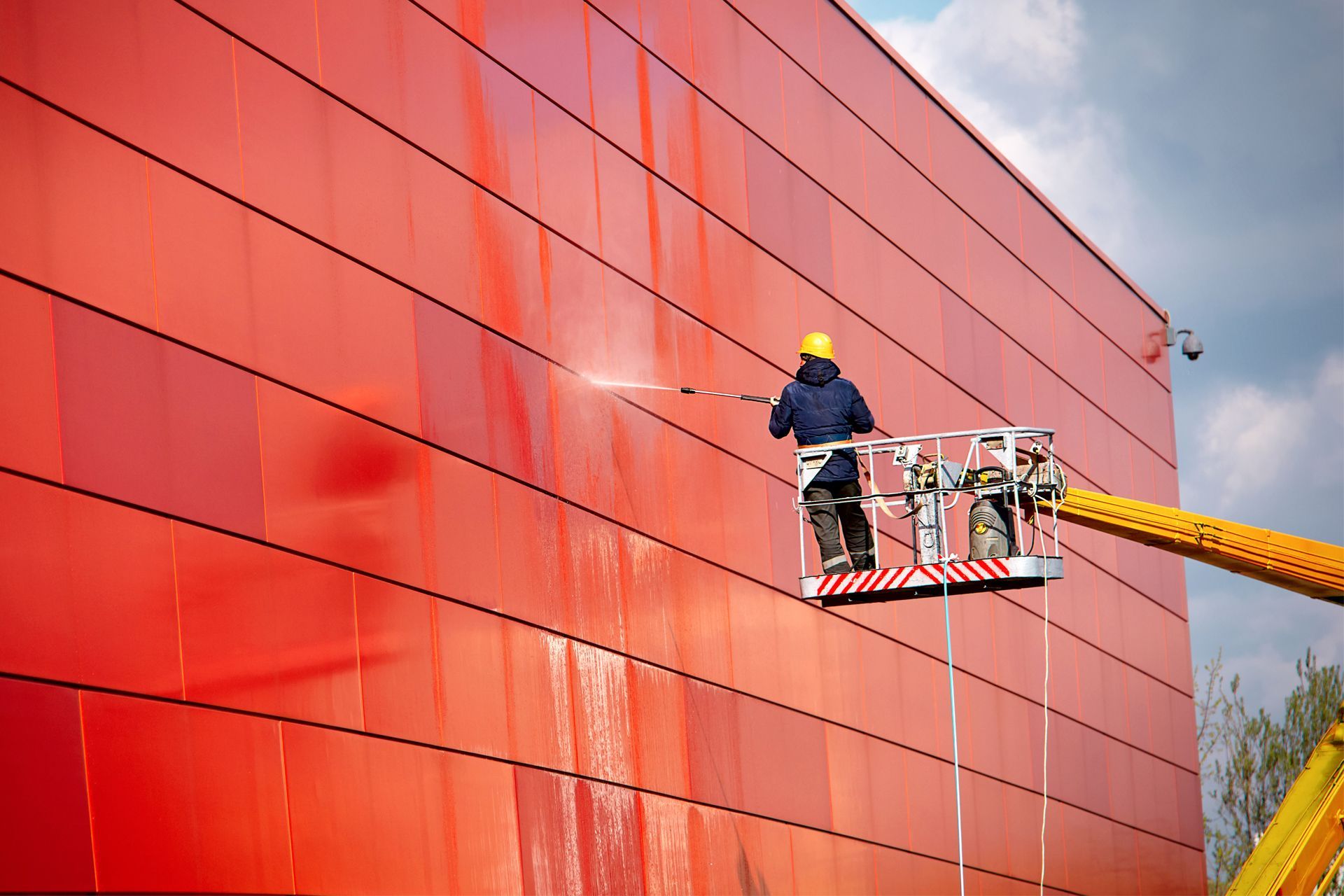 cleaning commercial building exterior with power washer