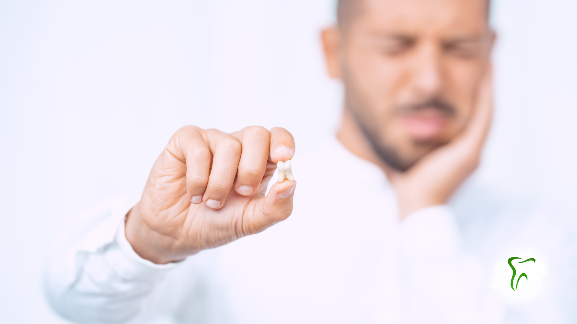 Man holding out a swollen, injured hand in front of his face, showing pain against a white background