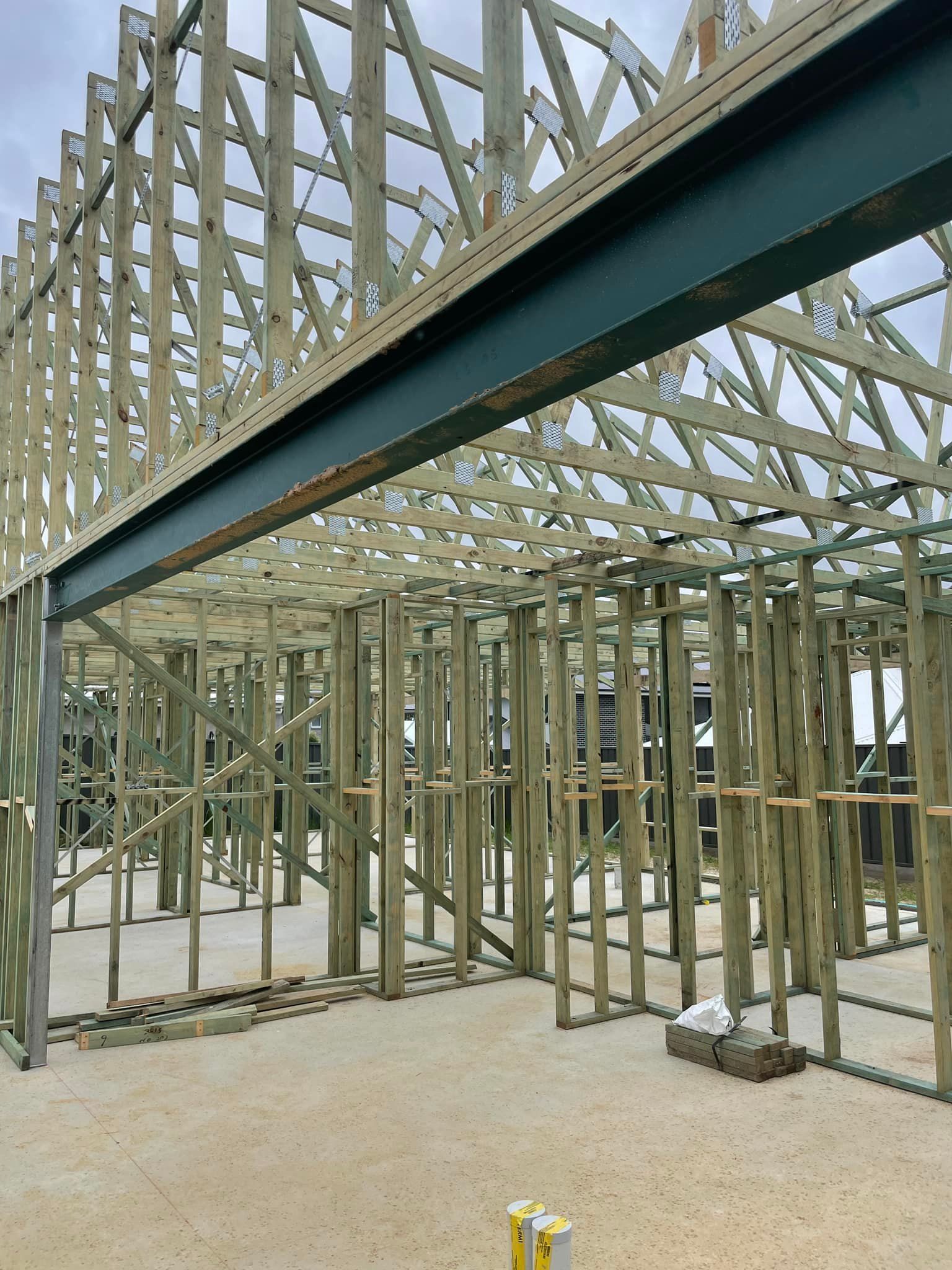 Wooden House Frame Under Construction, With Exposed Beams and Trusses — McNamara's Frames & Trusses In Maitland, NSW