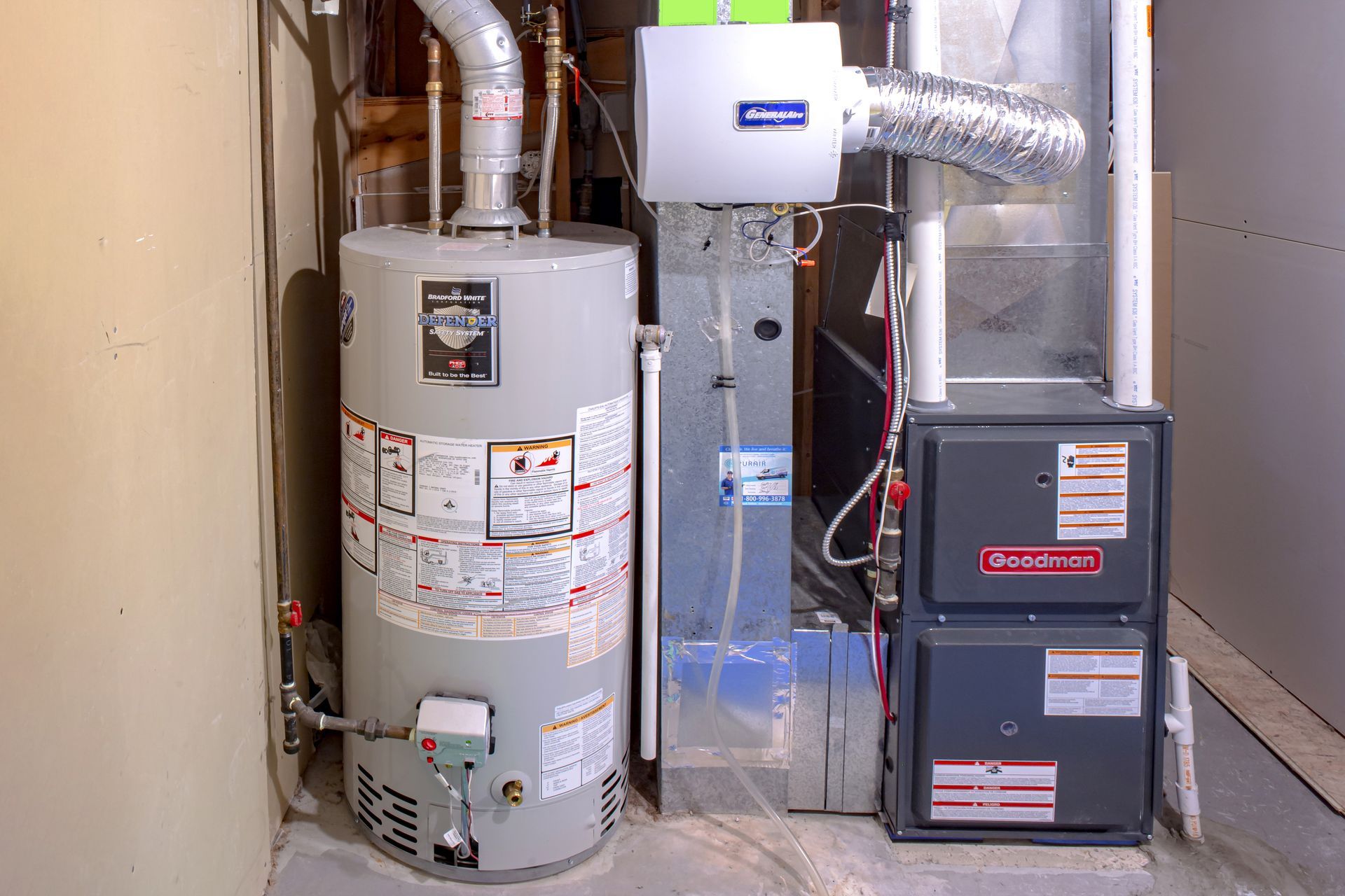 Water heater, furnace, and humidifier against a wall in a basement.