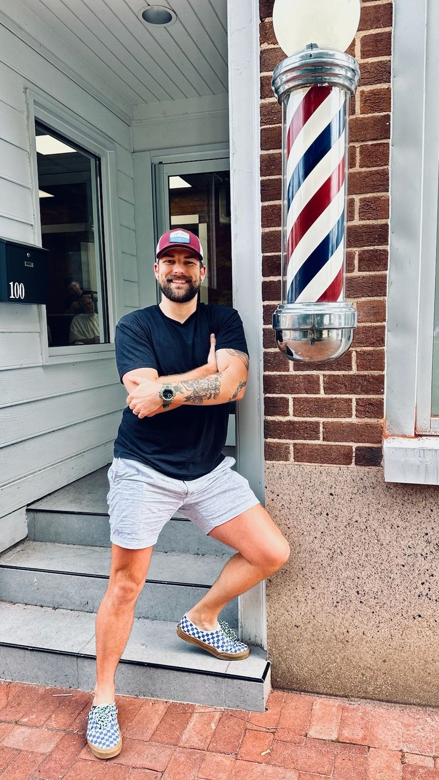 The logo for who 's your barber shows a man with a question mark on his face.