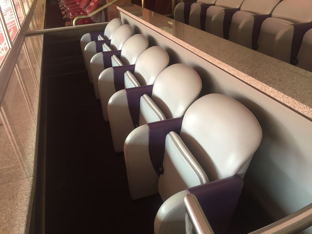 Row of white and purple theater seats.