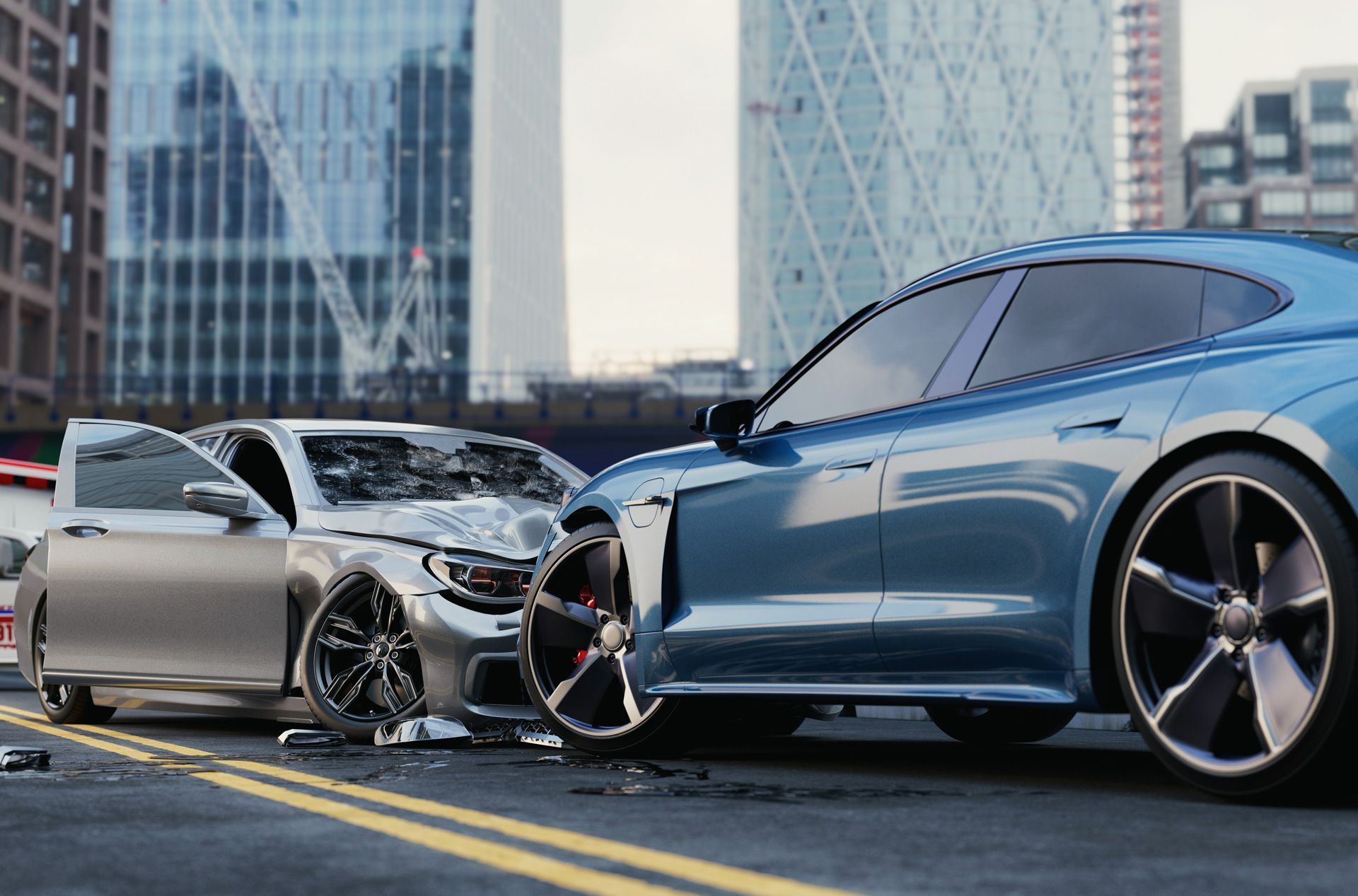 Cars in a city street, one wrecked silver car, one blue car undamaged, urban setting.