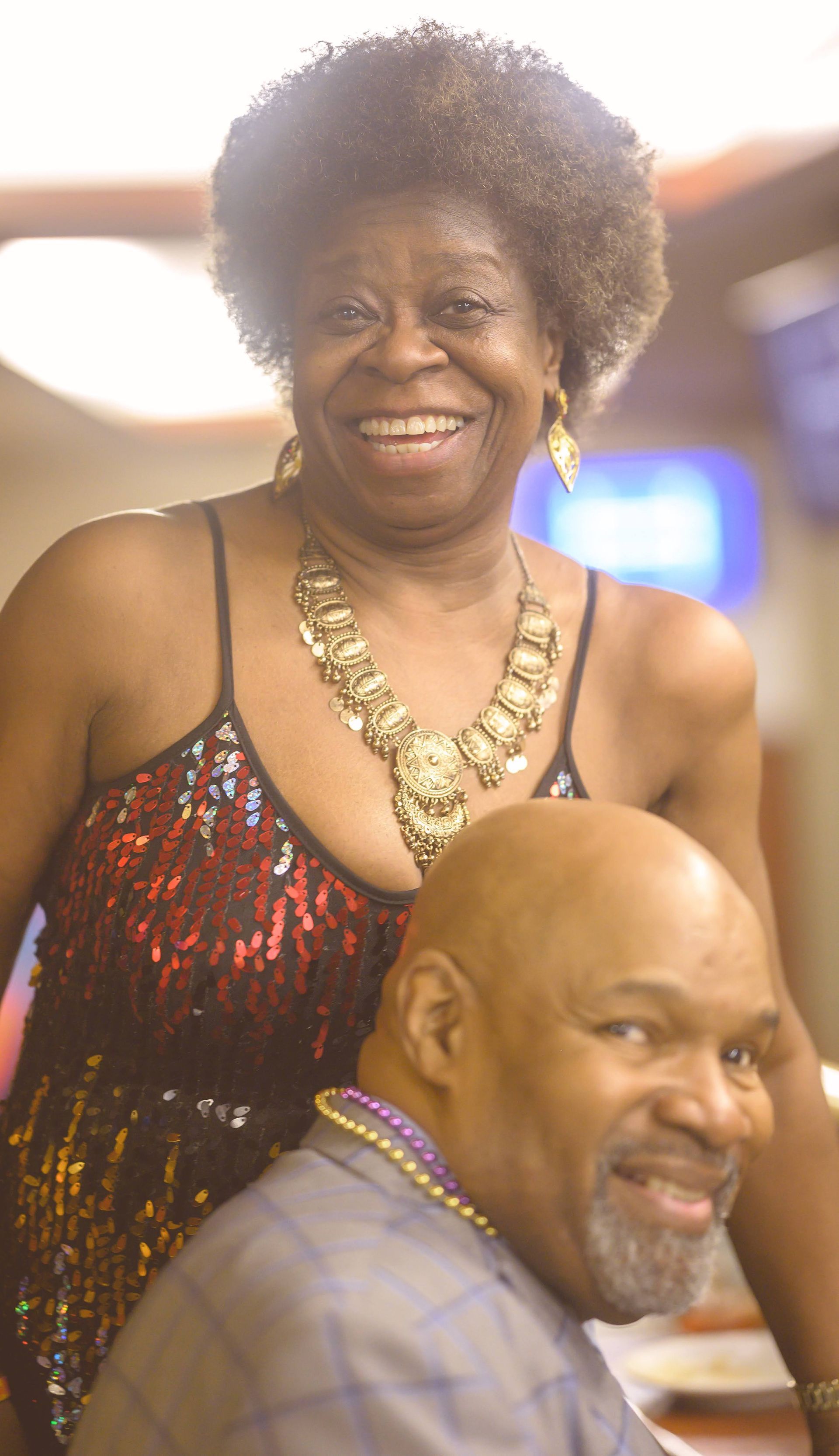 A man and a woman are sitting next to each other and smiling.