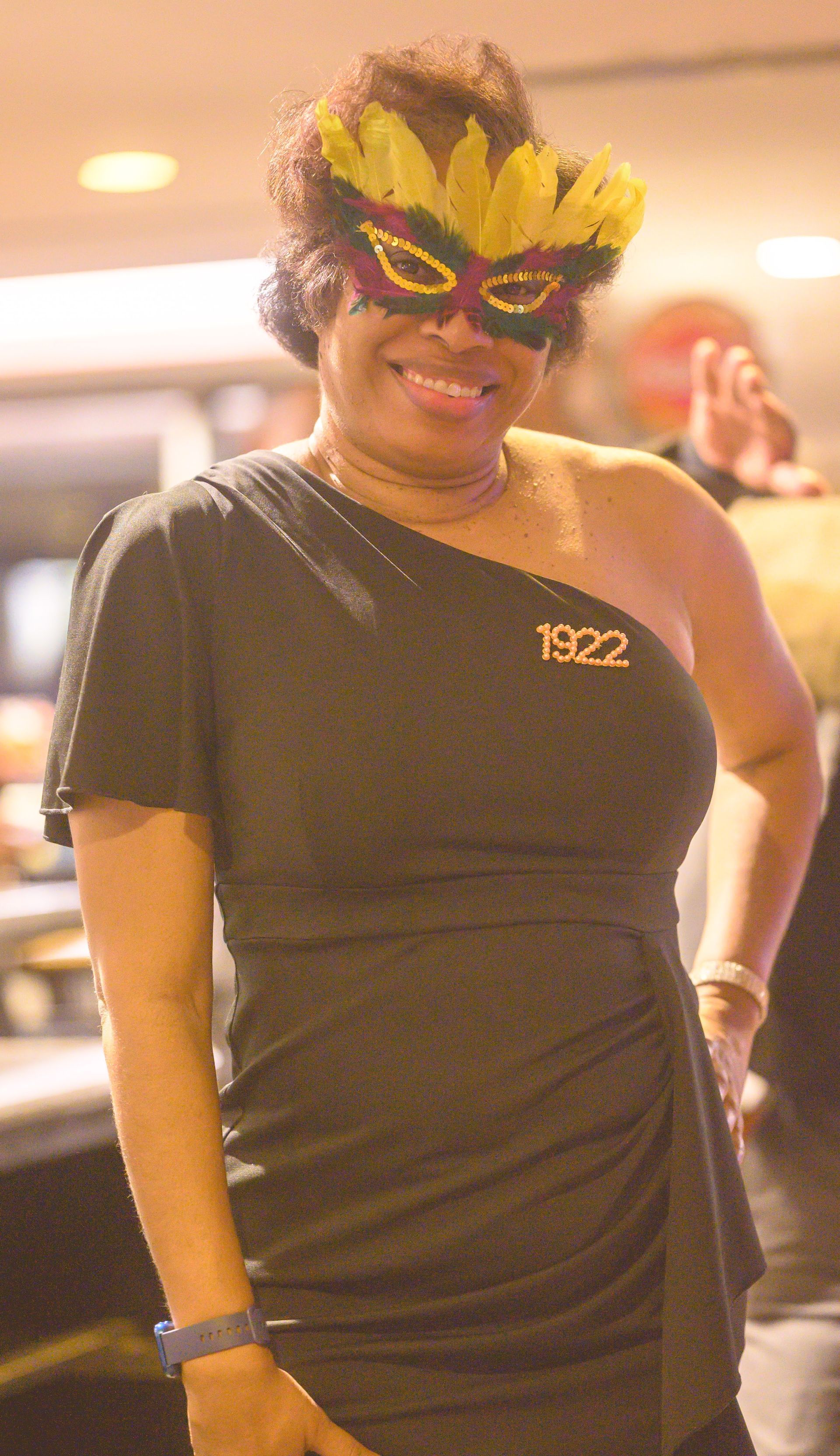A woman wearing a mask with the year 1922 on her shirt