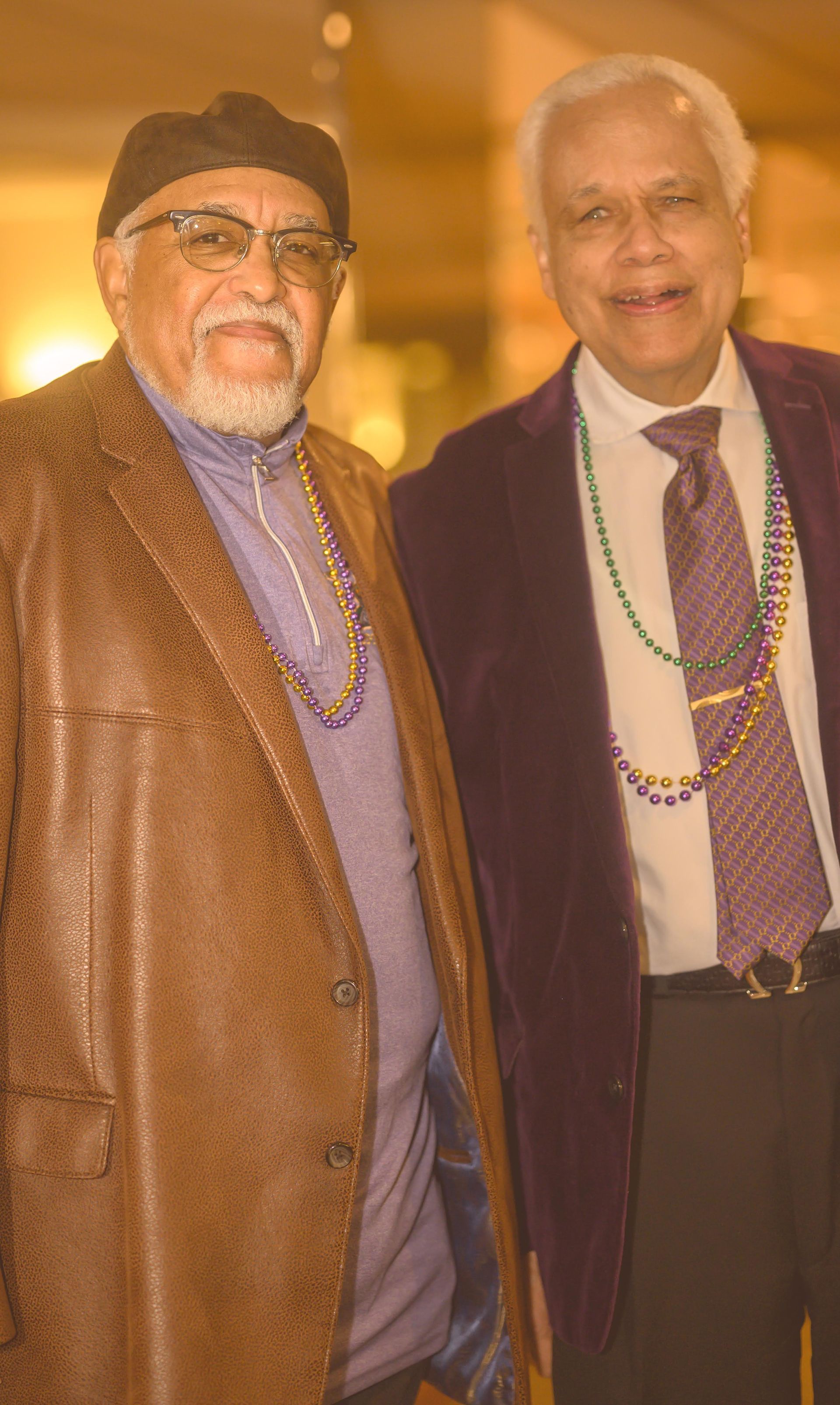 Two men in suits and ties are posing for a picture.
