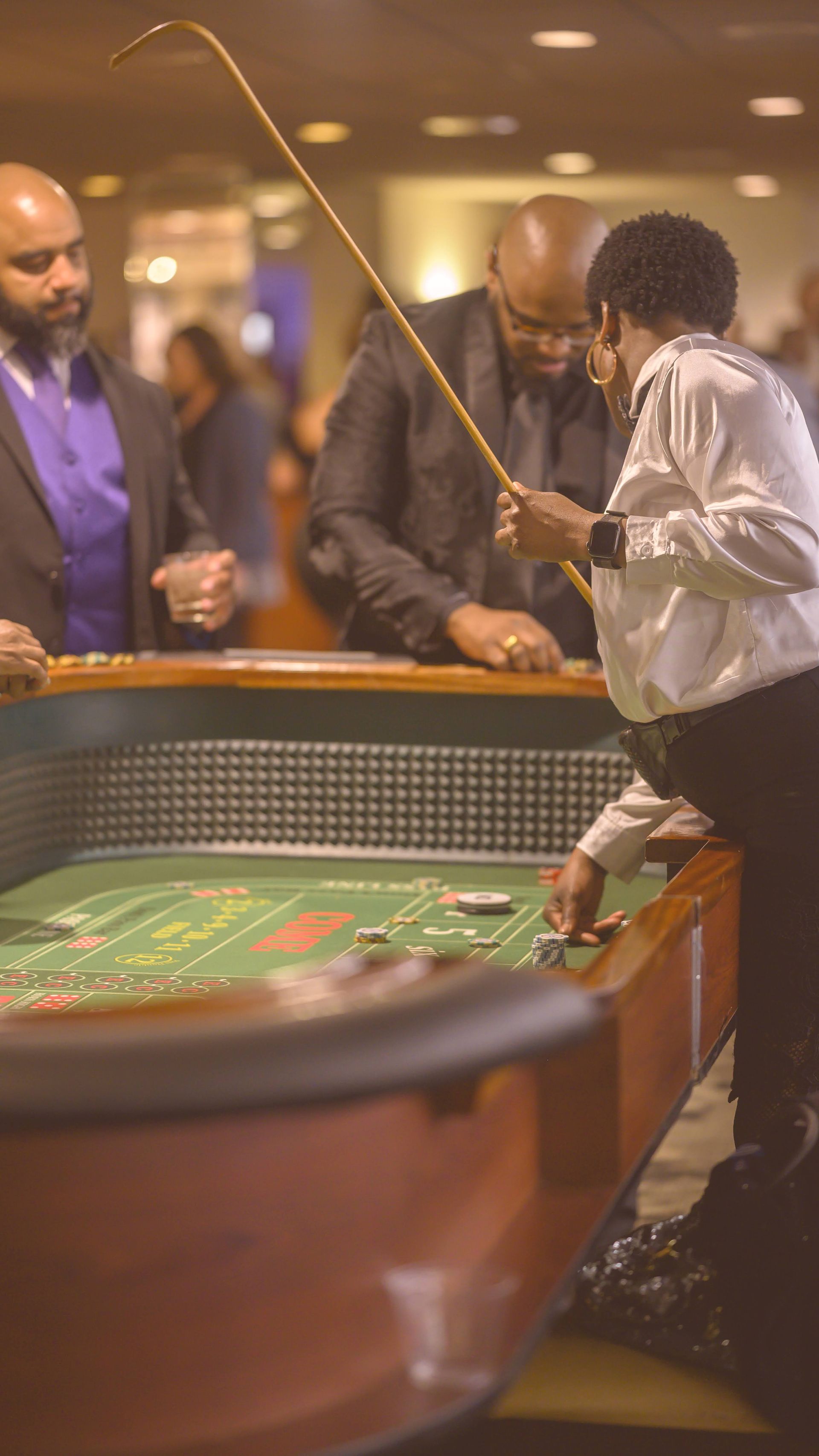 A group of people are playing roulette in a casino.