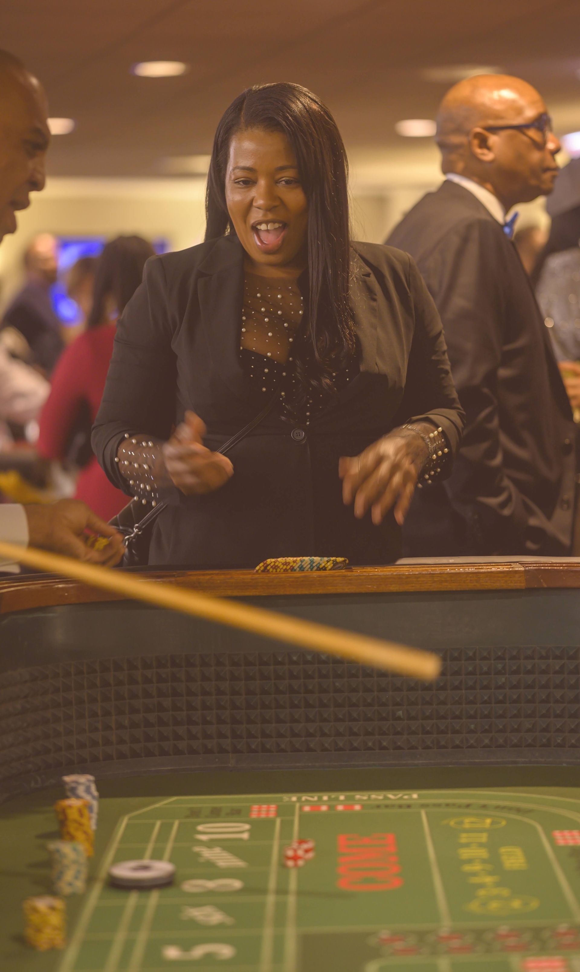 A woman is playing a game of craps in a casino.