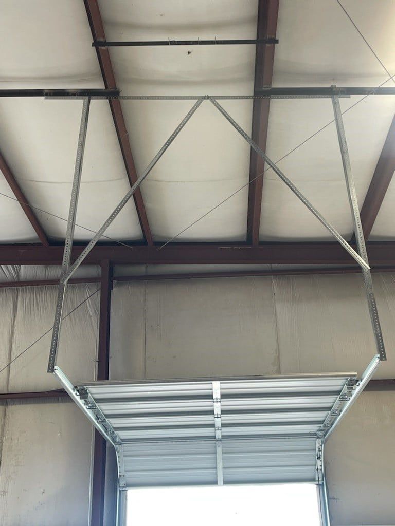 Industrial warehouse interior with a suspended metal platform under a high ceiling and support beams