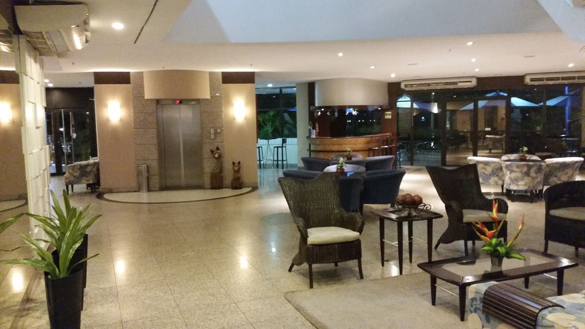 Um lobby de hotel com cadeiras e mesas