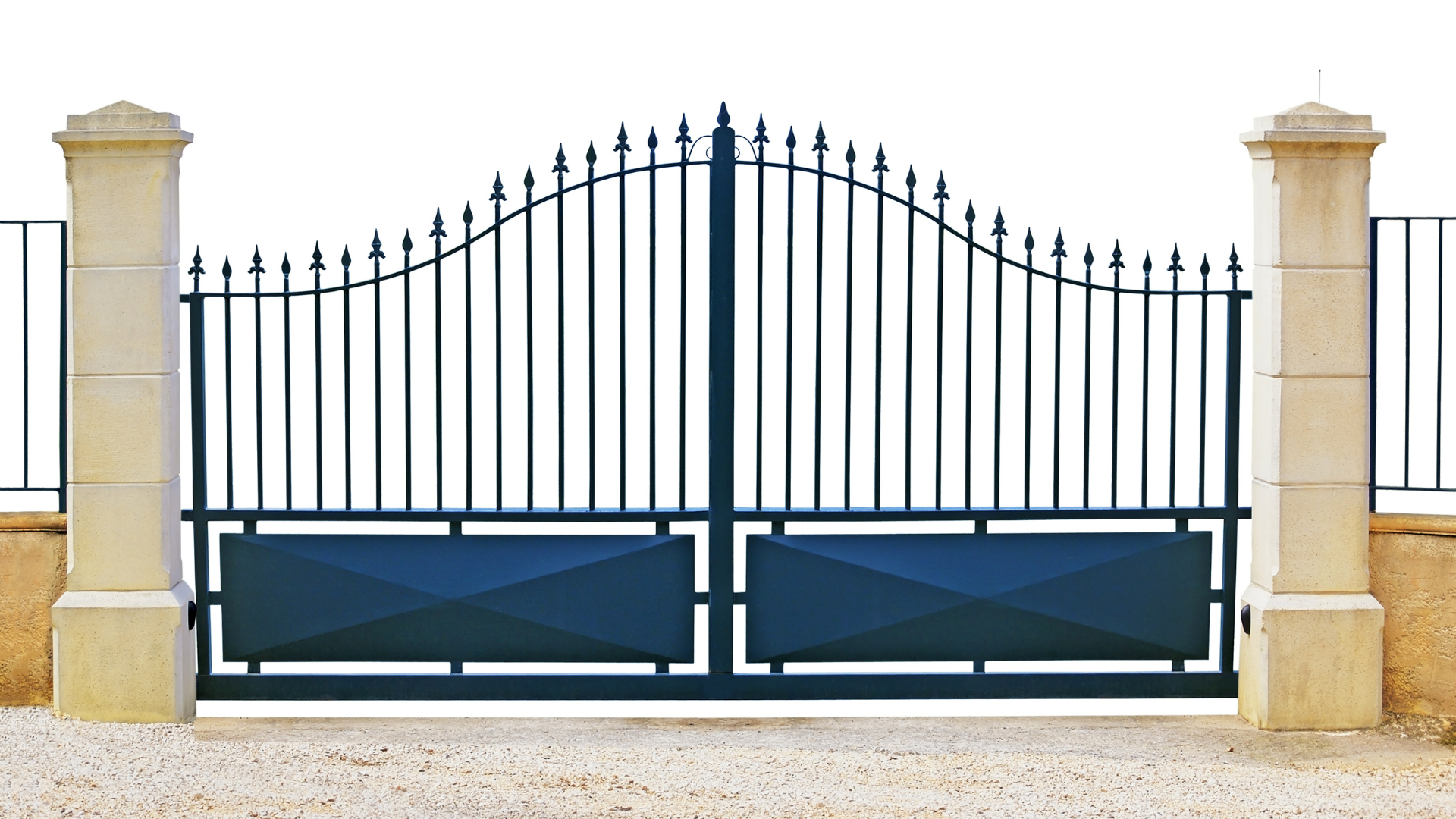 Black iron gate between stone pillars, leading to a driveway, with white background.