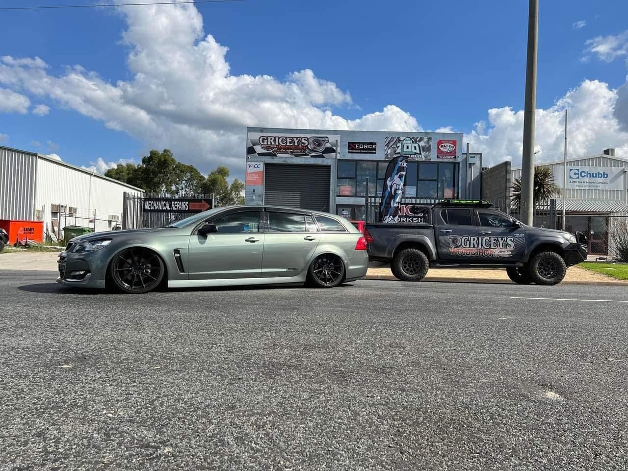 A Truck and a Sports Car Are on a Lift in a Garage — Gricey's Workshop Automotive Specialist in West Wodonga, VIC
