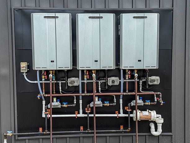 A white boiler enclosed in a wooden cabinet against a brick wall, with teal squares and a window visible.