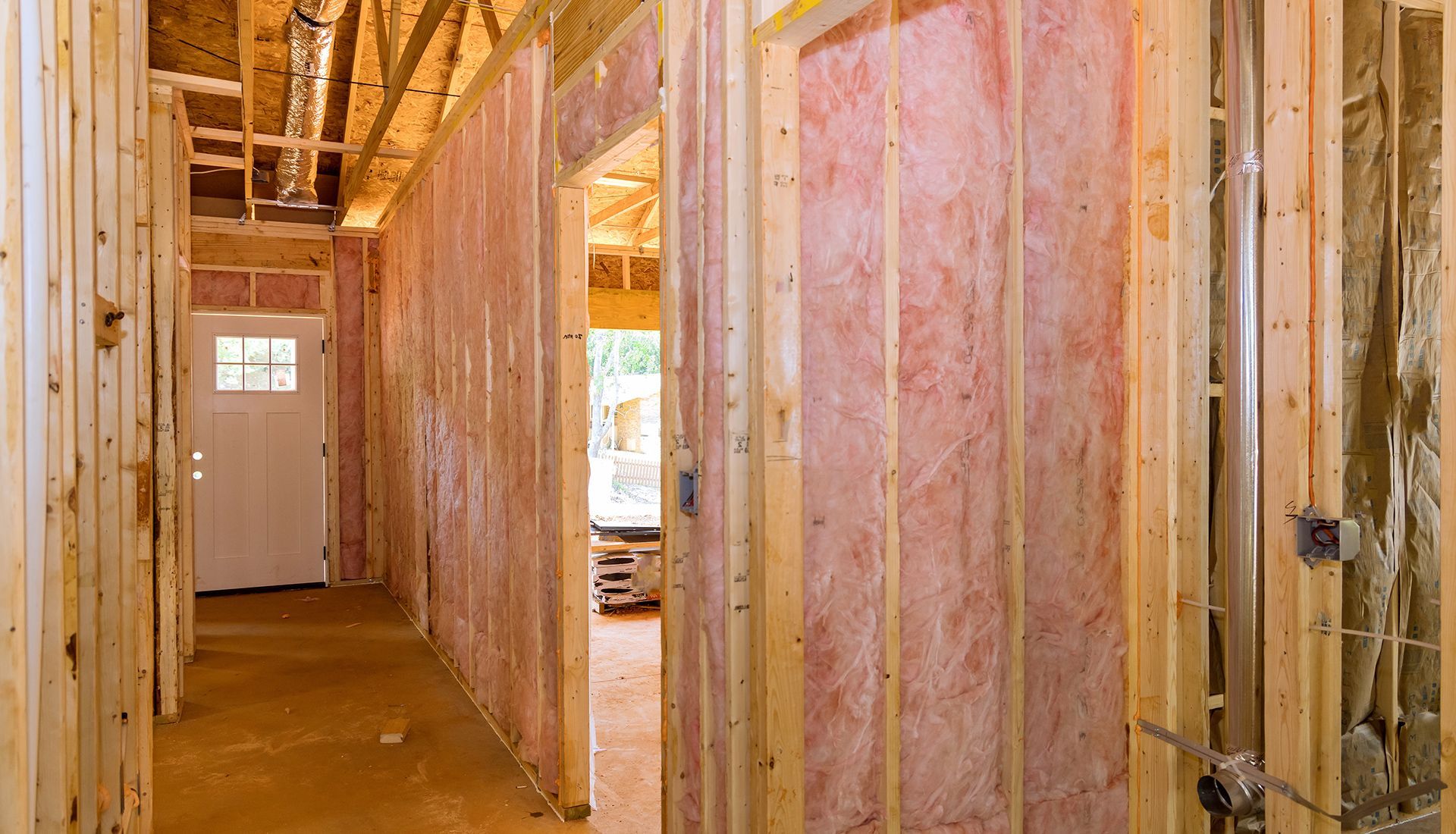 A hallway in a house under construction with insulation on the walls.