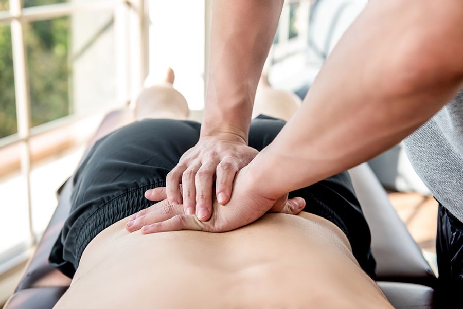 A Man is Getting a Massage on His Back — Mark O'Brien Chiropractic in West End, QLD