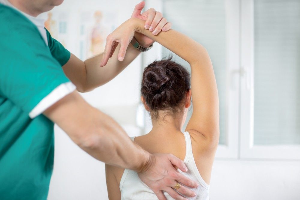 A Woman is Getting a Massage From a Doctor — Mark O'Brien Chiropractic in West End, QLD