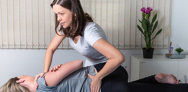 A Woman is Giving a Massage to Another Woman — Mark O'Brien Chiropractic in West End, QLD