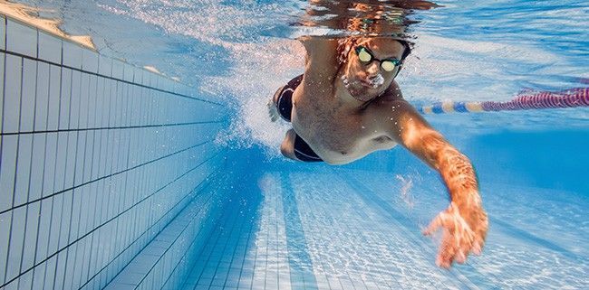 A Man is Swimming Underwater in a Swimming Pool — Mark O'Brien Chiropractic in West End, QLD