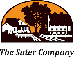 Logo for The Suter Company: farmhouses, fence, and tree silhouetted against an orange sunset.