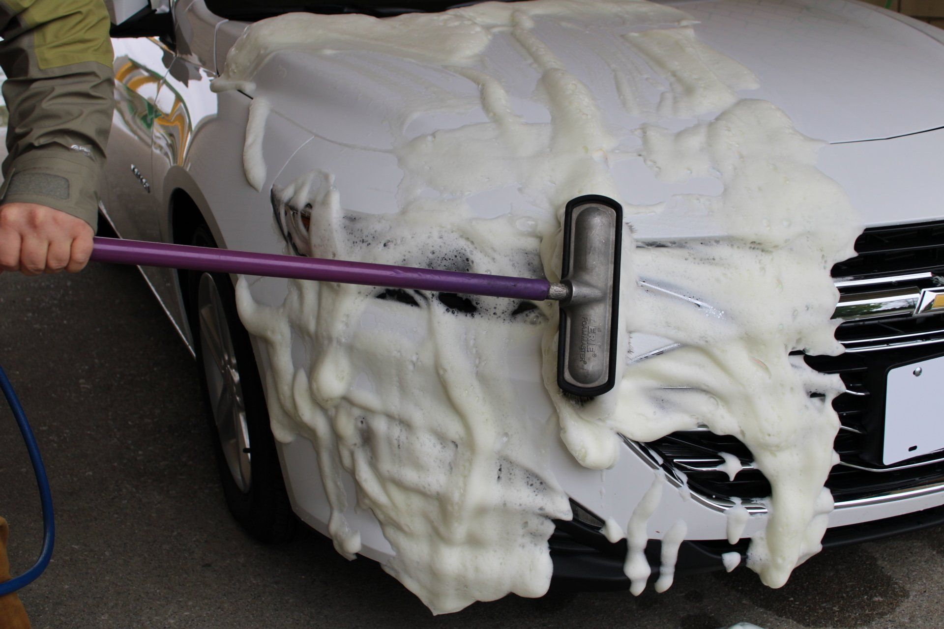 Woman washing her vehicle in a self serve station