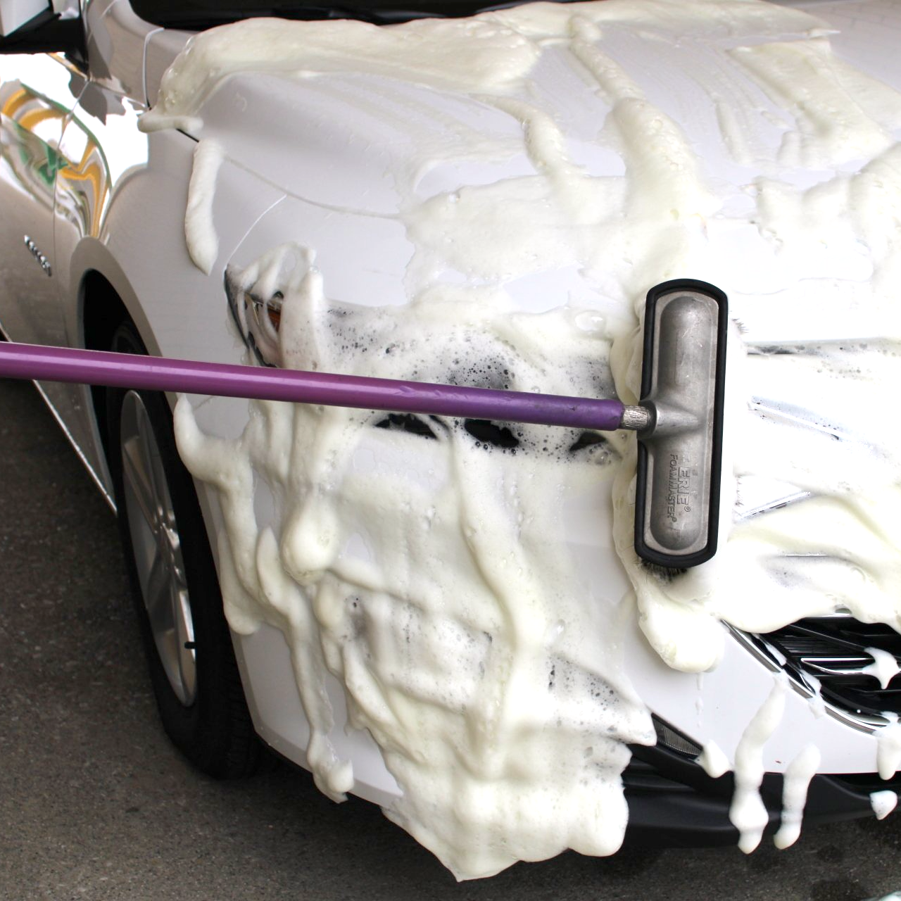 Woman washing her vehicle in a self serve station