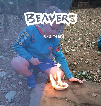 A boy is kneeling down with a candle in front of him and the word beavers is above him