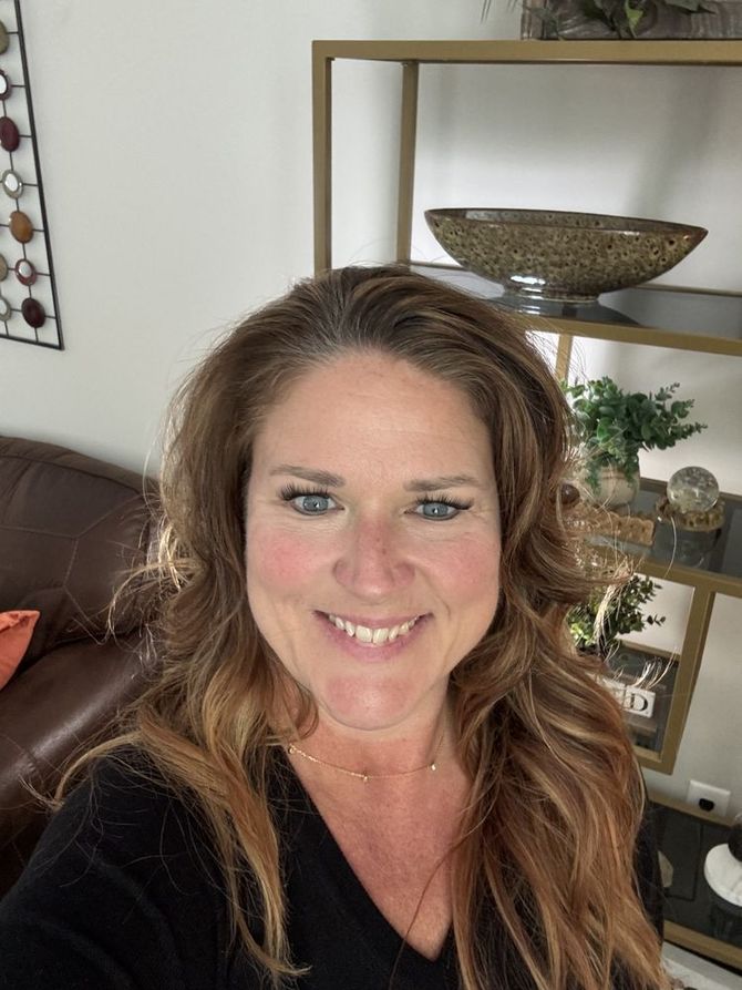 A living room with a brown couch and orange pillows Kristen Burrus, licensed therapist in Overland Park, Kansas