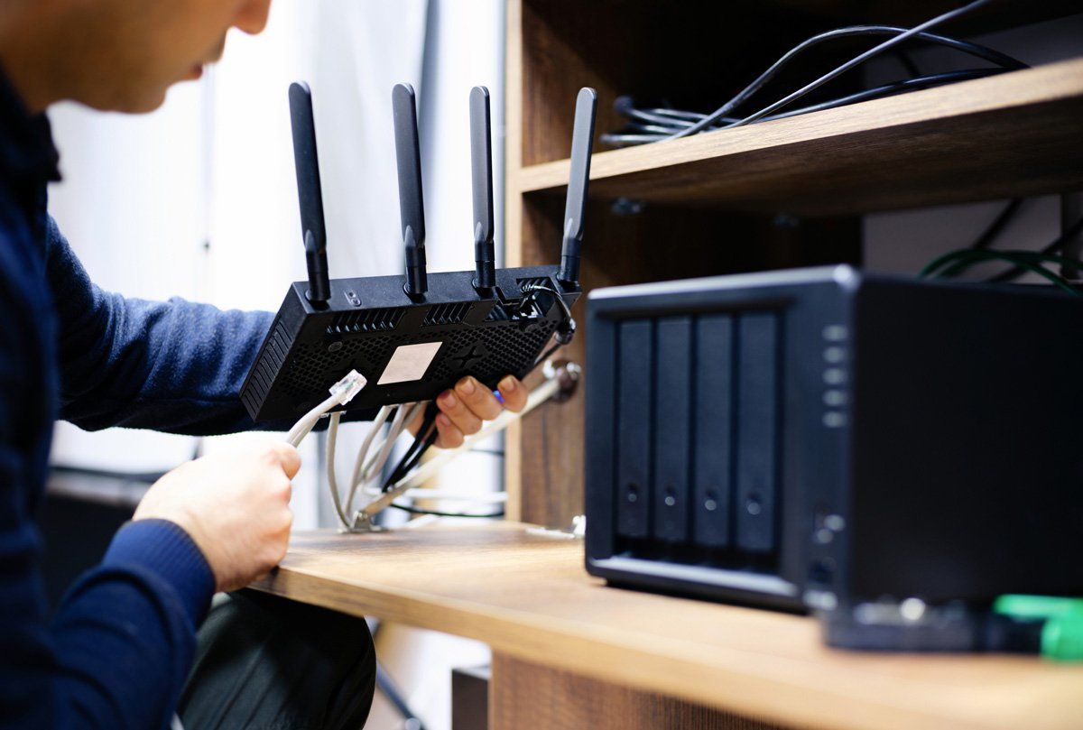 Man Preparing Cables for Network Attached Storage System — Los Angeles, CA — The Phone Smith
