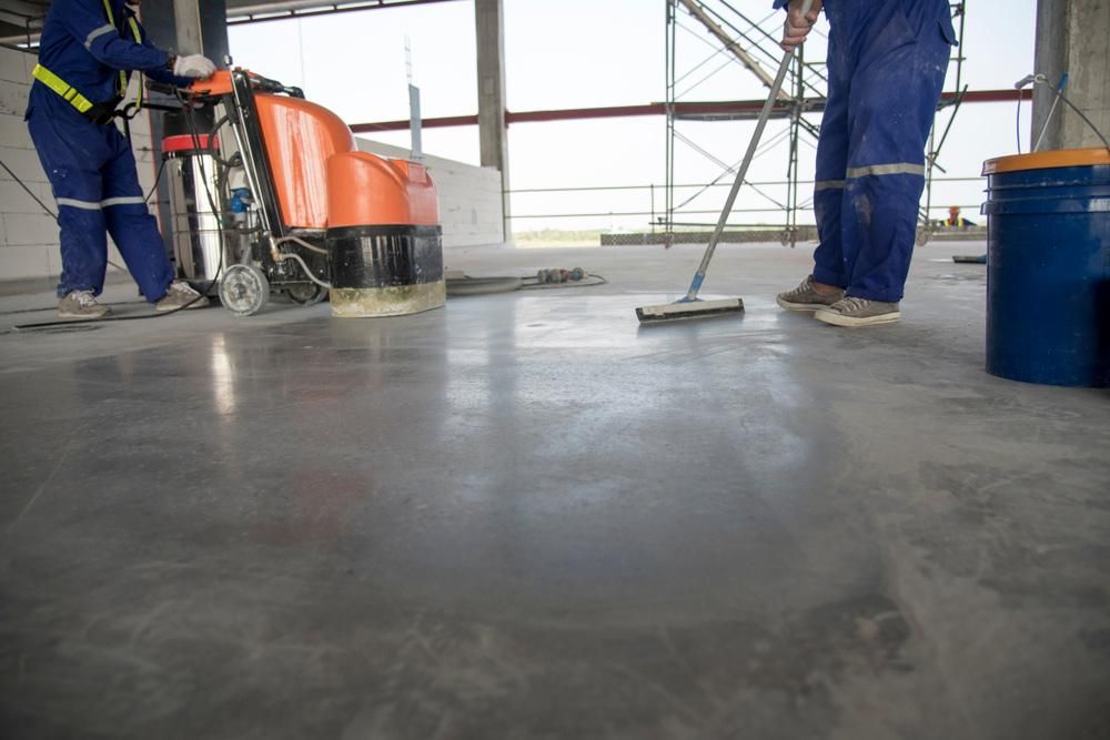 Two Men Are Cleaning the Floor of a Building — Capital Ultimate Facility in Beard, ACT