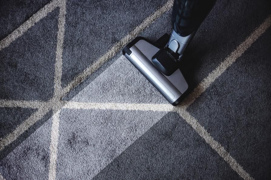 Person is Using a Vacuum Cleaner to Clean a Carpet — Capital Ultimate Facility in Beard, ACT