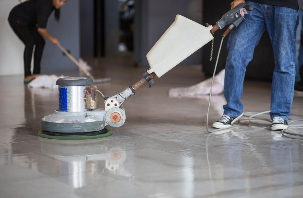 Man is Polishing a Marble Floor With a Machine — Capital Ultimate Facility in Belconnen, ACT