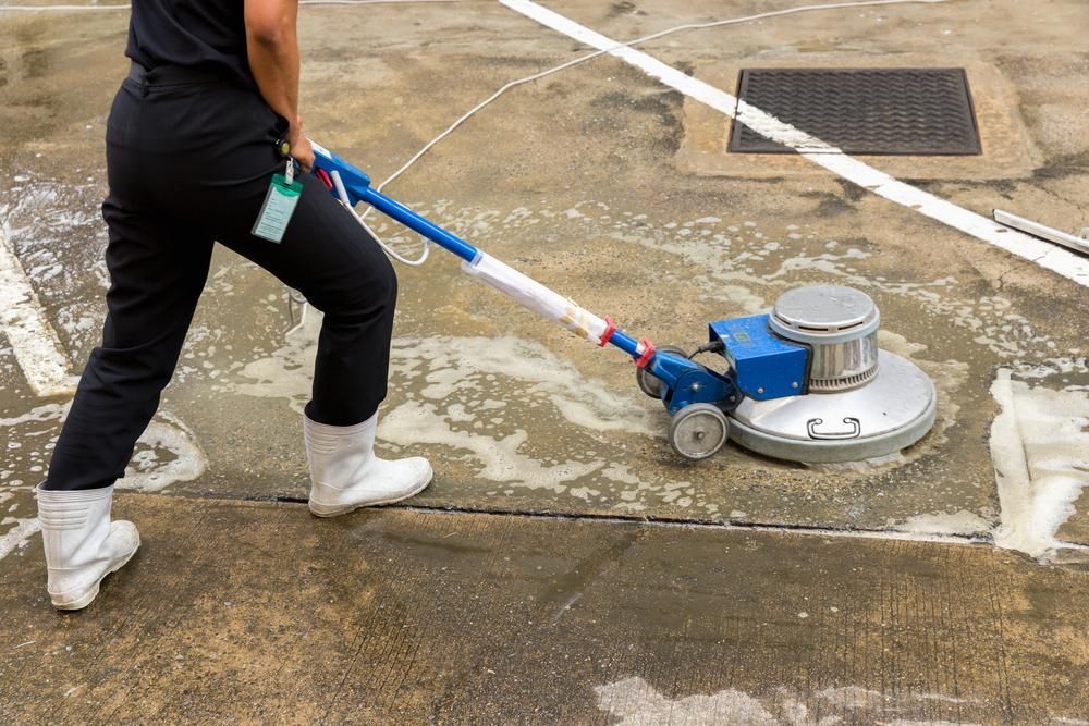 Woman is Using a Machine to Clean a Concrete Floor — Capital Ultimate Facility in Beard, ACT