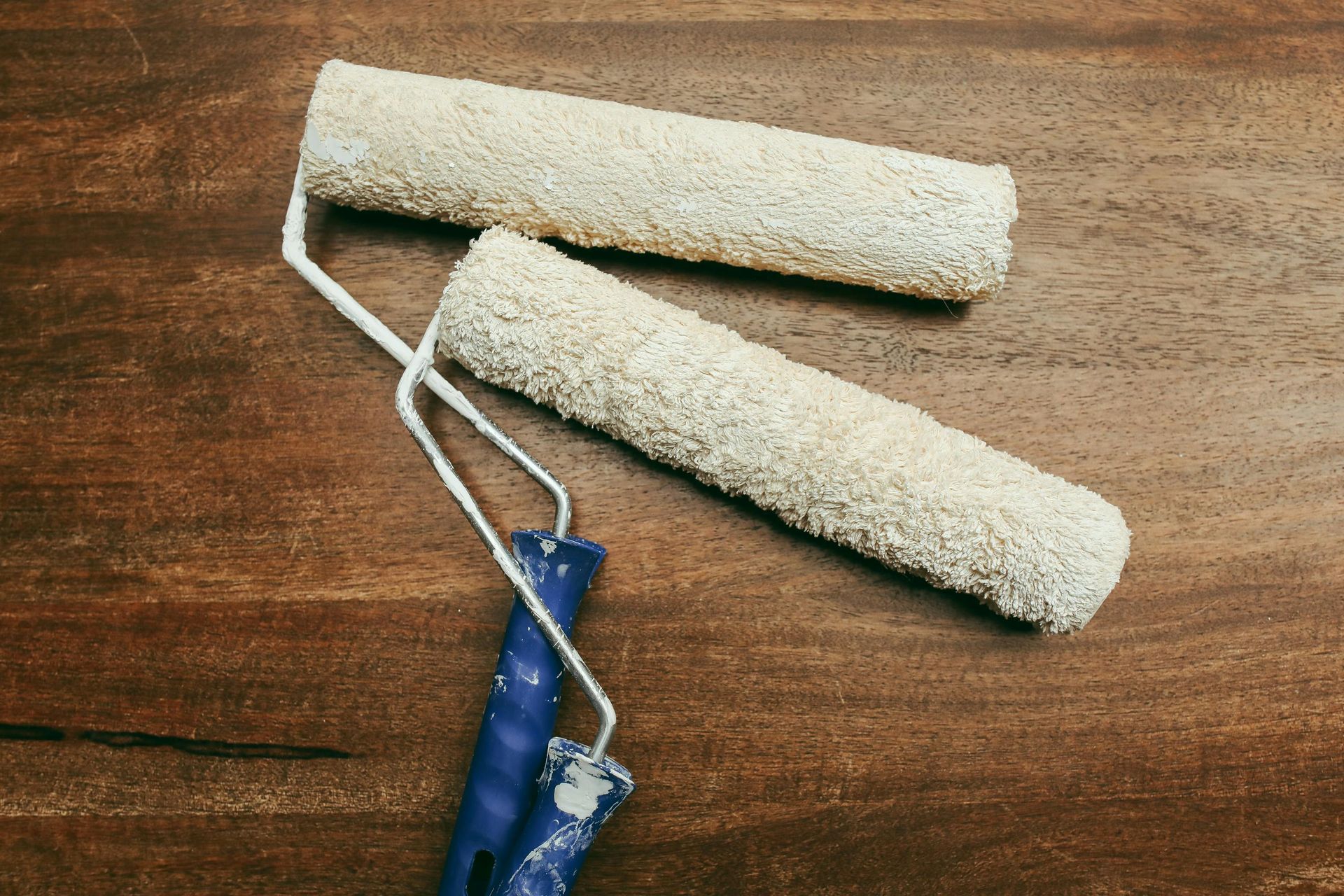 Two paint rollers are sitting on a wooden table. — Capital Ultimate Facility in Beard, ACT