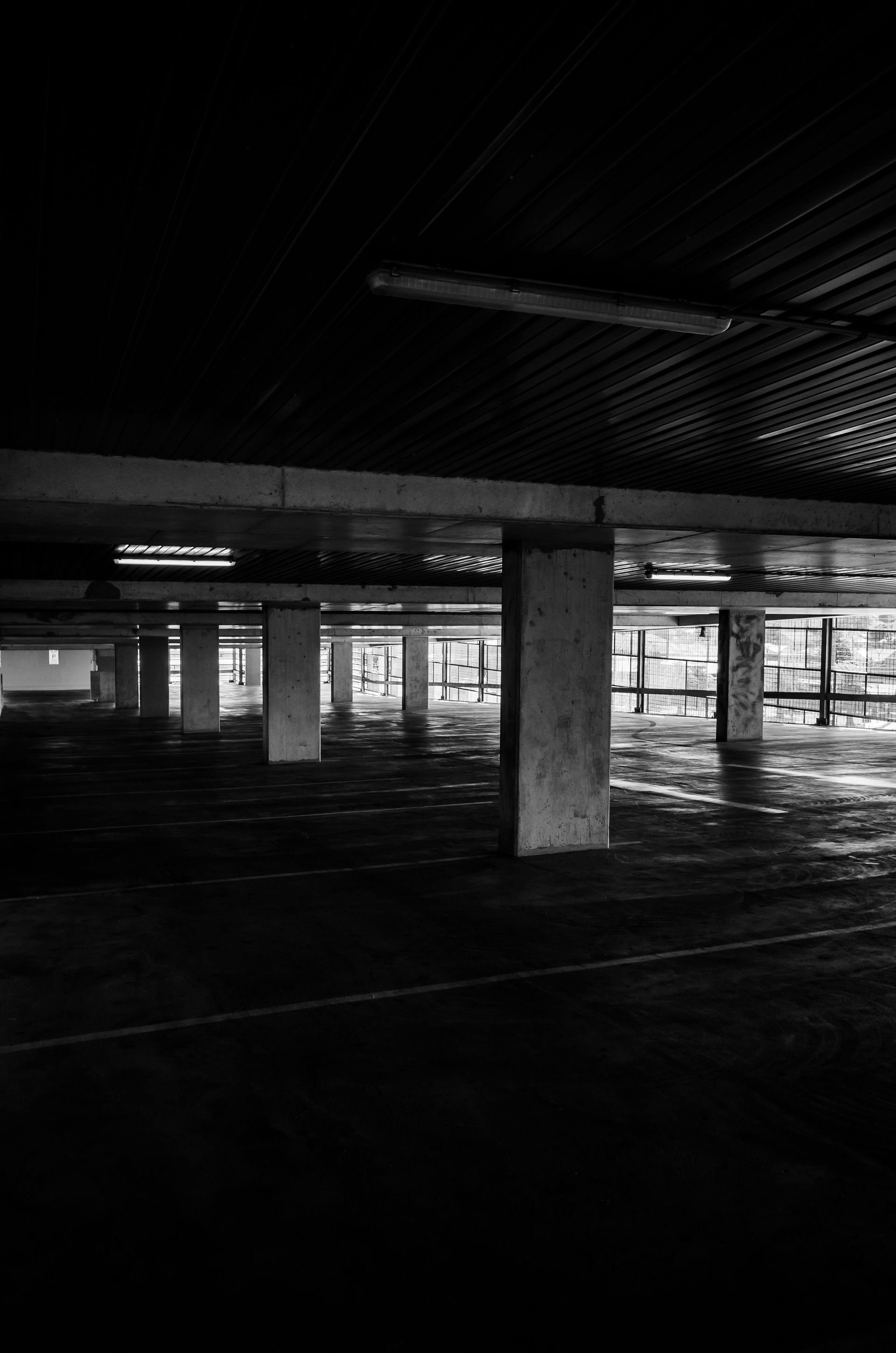 A black and white photo of an empty parking garage at night. — Capital Ultimate Facility in Belconnen, ACT