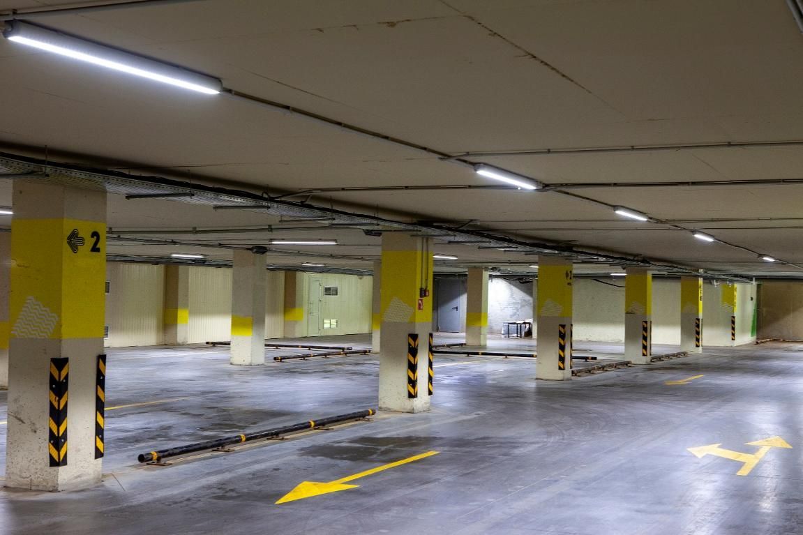 An Empty Parking Garage With Yellow Columns and Arrows — Capital Ultimate Facility in Belconnen, ACT