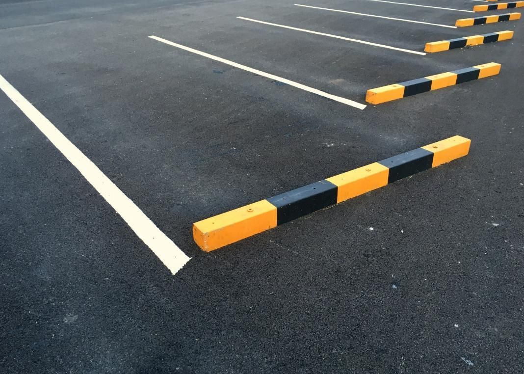 Row of Yellow and Black Parking Blocks in a Parking Lot — Capital Ultimate Facility in Canberra, ACT