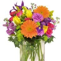 Colorful mixed bouquet of flowers in a clear glass vase